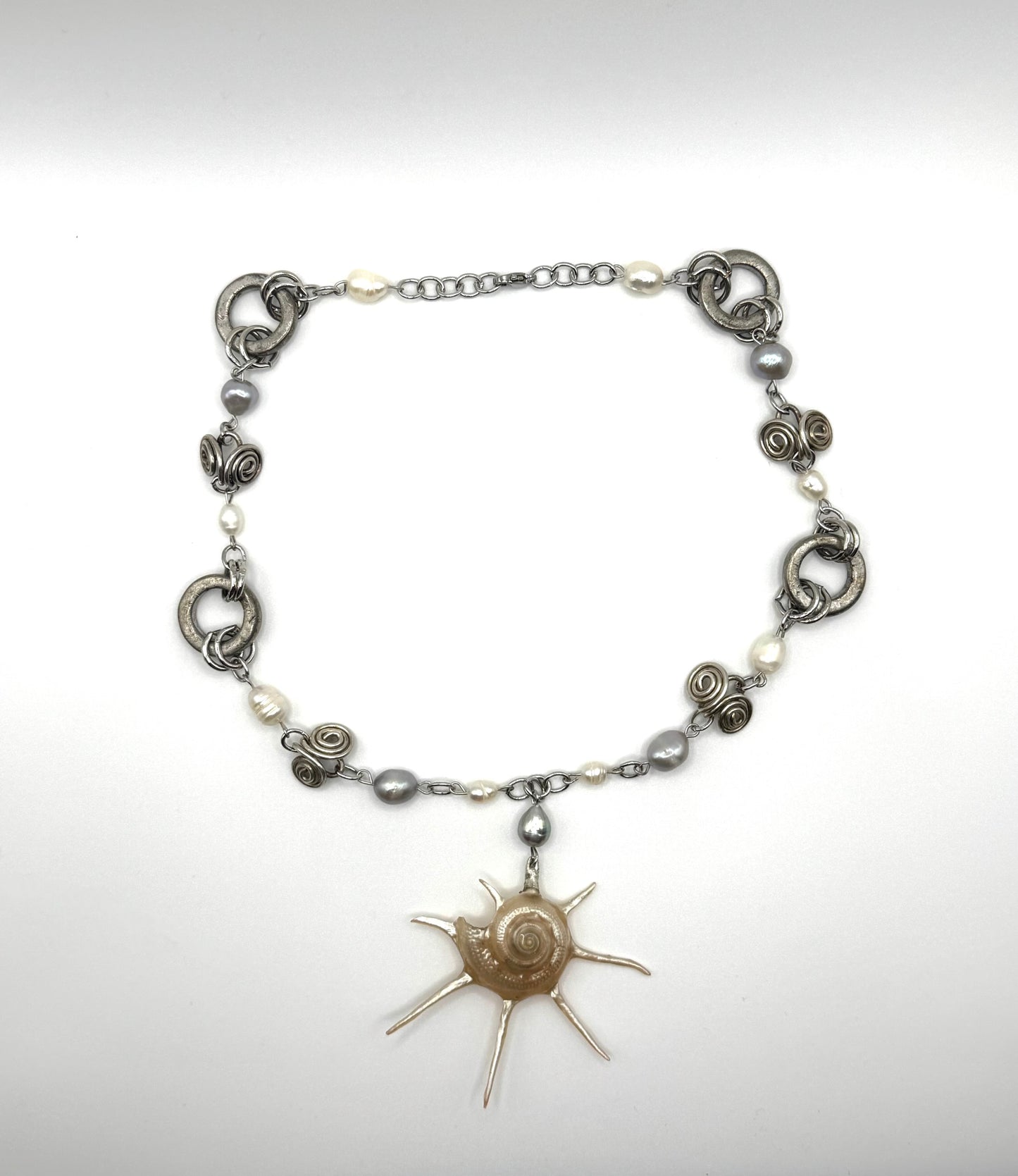 A spike shell siren necklace